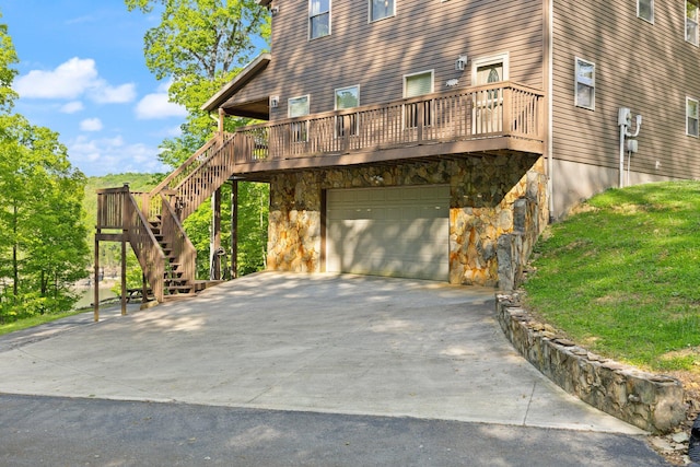 view of property exterior with an attached garage, stairway, driveway, and stone siding