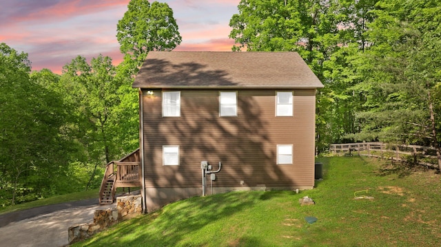 view of home's exterior with a wooden deck, fence, cooling unit, a lawn, and stairway