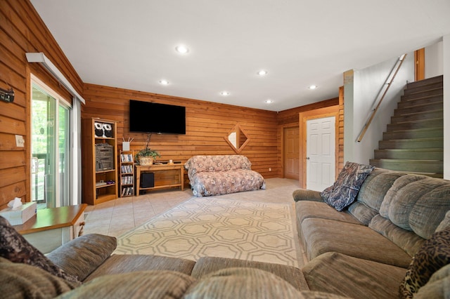 living area featuring stairway, wood walls, light tile patterned floors, and recessed lighting