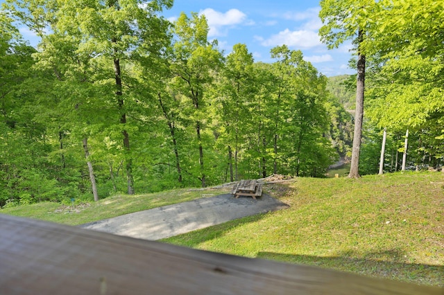surrounding community featuring a wooded view