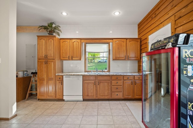 kitchen featuring white dishwasher, refrigerator, brown cabinetry, and a sink