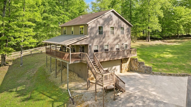 rear view of property with stairs, an attached garage, a deck, concrete driveway, and a yard