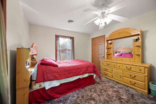 bedroom with carpet floors, ceiling fan, and visible vents