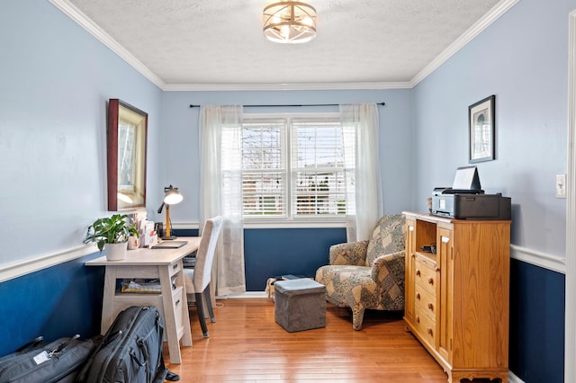 office space with crown molding, baseboards, light wood-type flooring, and a textured ceiling