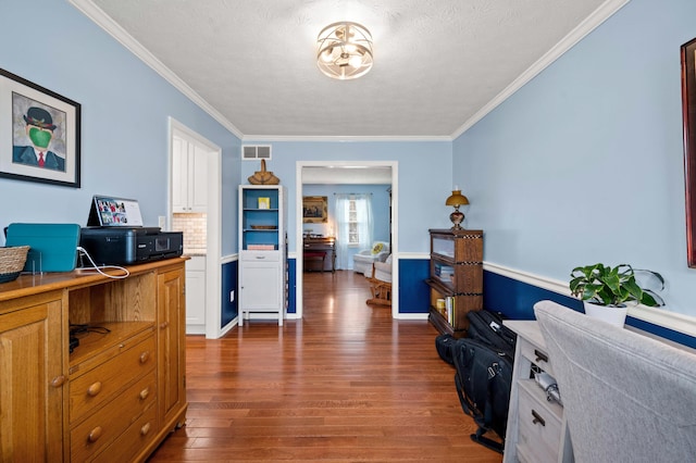 office featuring visible vents, crown molding, and dark wood-style floors
