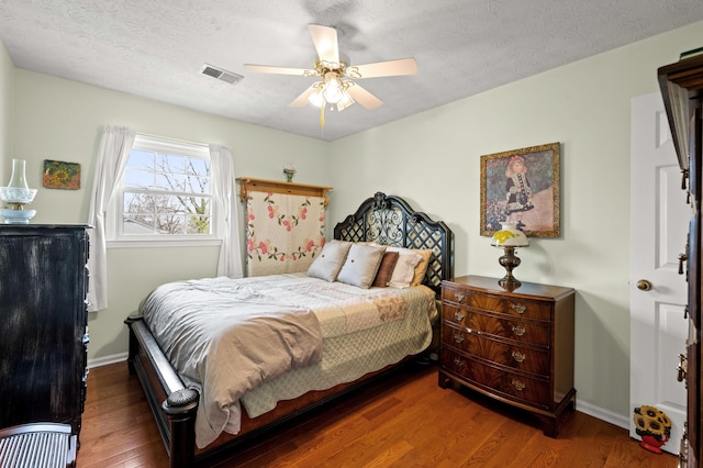 bedroom with baseboards, ceiling fan, and wood finished floors