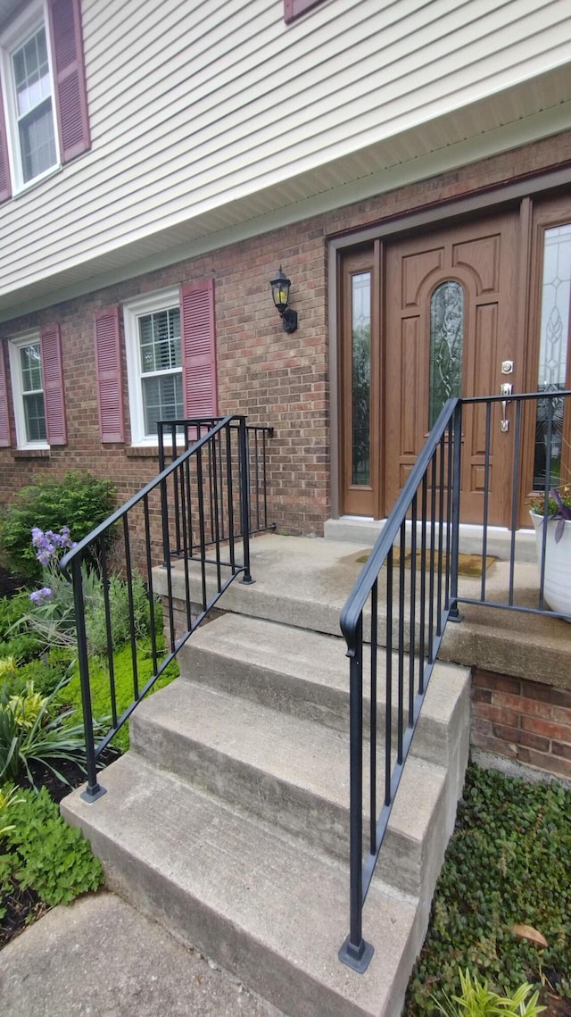 view of exterior entry with brick siding