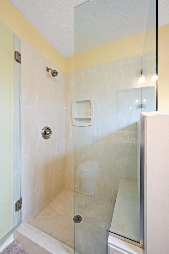 full bathroom featuring a marble finish shower