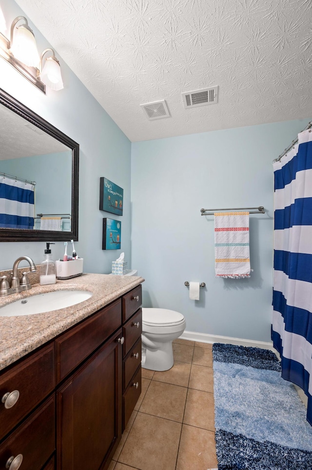 bathroom with visible vents, tile patterned flooring, toilet, and vanity