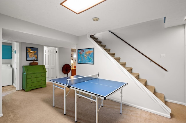 game room with washer / clothes dryer, baseboards, and light carpet