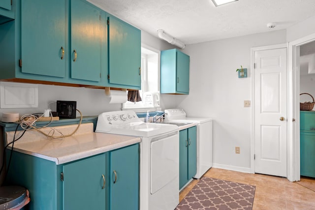 laundry room featuring cabinet space, independent washer and dryer, baseboards, and a textured ceiling