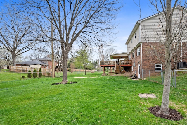 view of yard with central air condition unit, a deck, a fenced backyard, and stairs