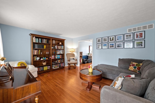 living room with visible vents and wood finished floors