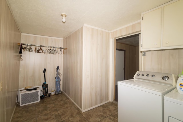 534 Lower Gilmore Rd, Campton, KY 41301 - clothes washing area with wood walls, washer and clothes dryer, a textured ceiling, dark tile patterned flooring, and cabinet space