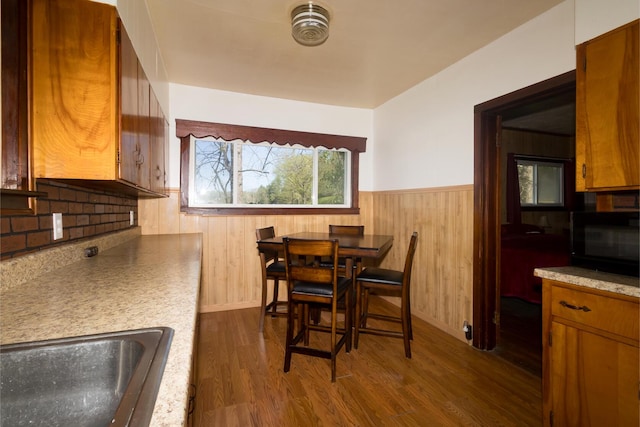 534 Lower Gilmore Rd, Campton, KY 41301 - dining room with baseboards, wood walls, dark wood-type flooring, and a wainscoted wall