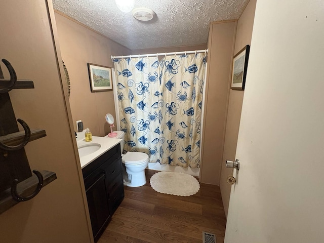 980 Persimmon Ridge Rd, Carlisle, KY 40311 - full bathroom featuring a textured ceiling, visible vents, wood finished floors, vanity, and toilet