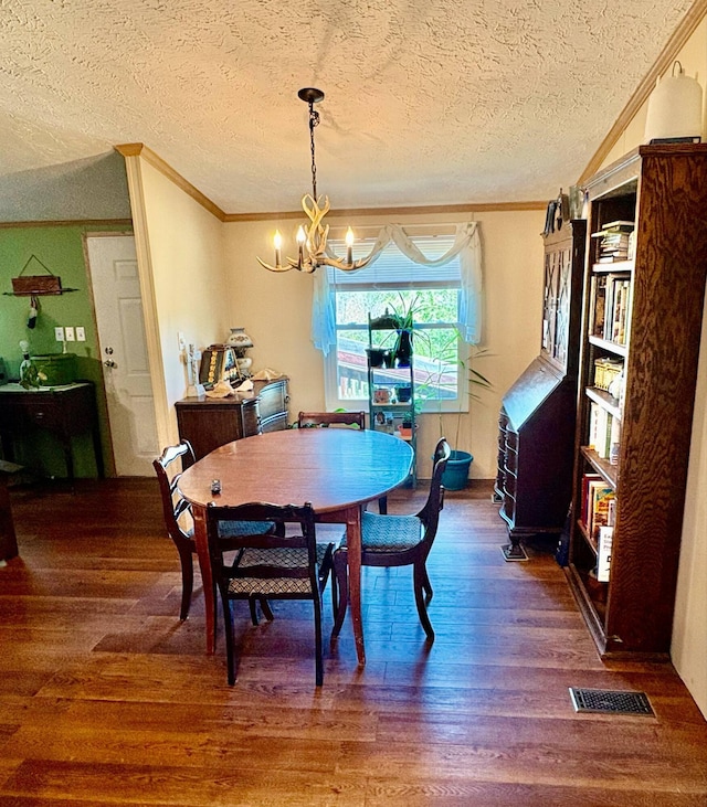 980 Persimmon Ridge Rd, Carlisle, KY 40311 - dining space featuring ornamental molding, a textured ceiling, wood finished floors, and a notable chandelier