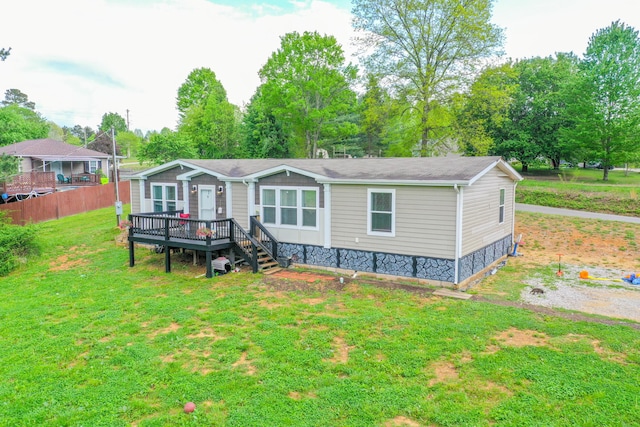 6989 W Laurel Rd, London, KY 40741 - view of front of home with a wooden deck, a front lawn, and fence