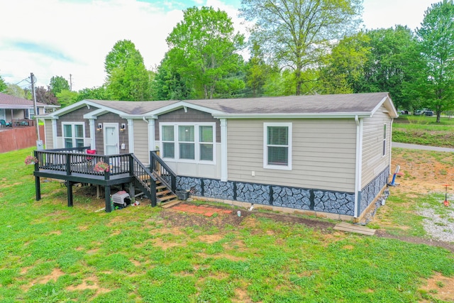 6989 W Laurel Rd, London, KY 40741 - manufactured / mobile home featuring a wooden deck and a front yard
