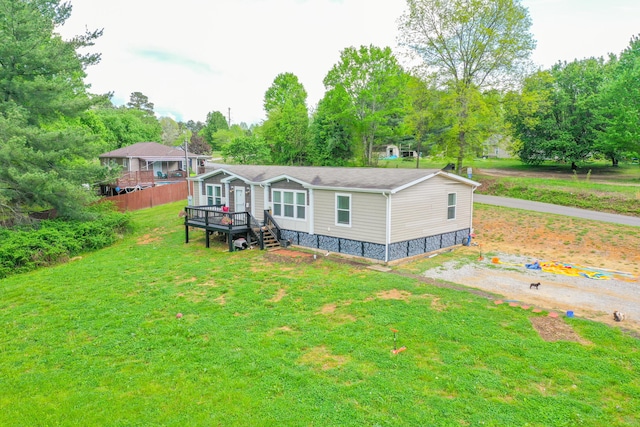 6989 W Laurel Rd, London, KY 40741 - rear view of house with a lawn and a wooden deck