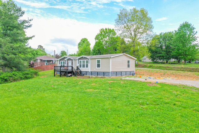 6989 W Laurel Rd, London, KY 40741 - rear view of house featuring a deck and a lawn