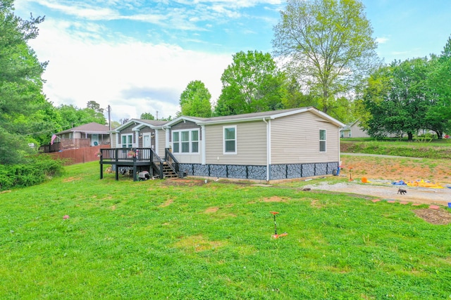 6989 W Laurel Rd, London, KY 40741 - rear view of house featuring a deck and a lawn