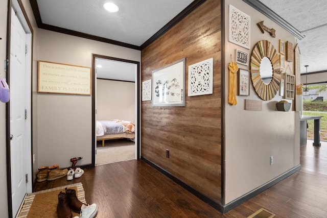 6989 W Laurel Rd, London, KY 40741 - corridor featuring wooden walls, crown molding, a textured ceiling, and wood finished floors