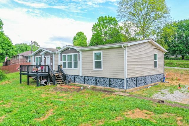 6989 W Laurel Rd, London, KY 40741 - rear view of property with a lawn and a wooden deck