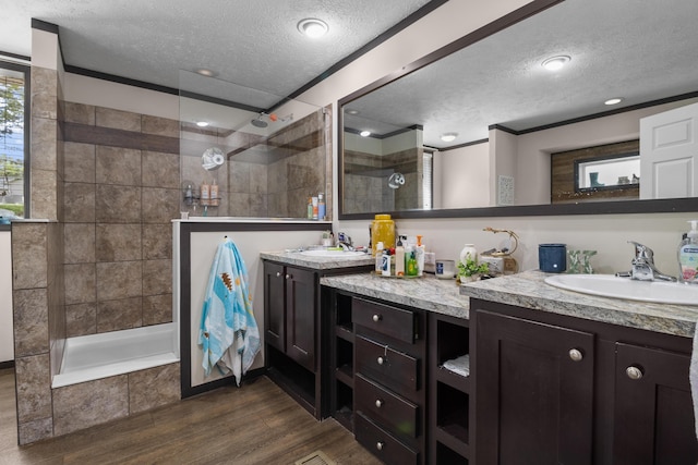 6989 W Laurel Rd, London, KY 40741 - bathroom featuring a sink, wood finished floors, a textured ceiling, a walk in shower, and double vanity