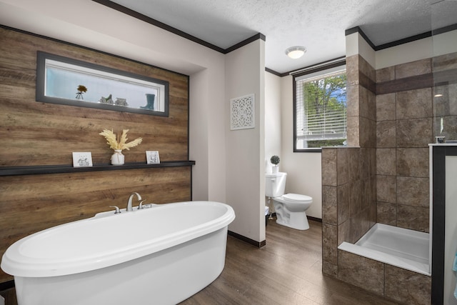 6989 W Laurel Rd, London, KY 40741 - full bathroom featuring toilet, wood finished floors, crown molding, a soaking tub, and baseboards