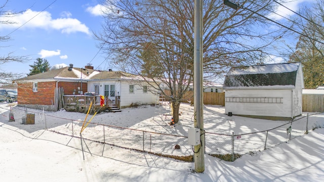 exterior space featuring an outbuilding, a wooden deck, and a fenced backyard