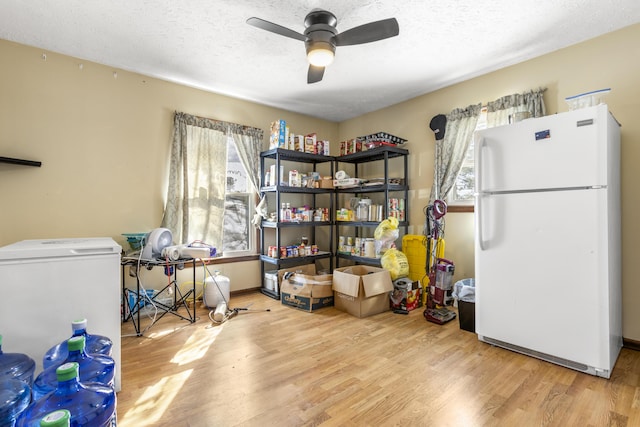 miscellaneous room with a textured ceiling, a ceiling fan, and wood finished floors