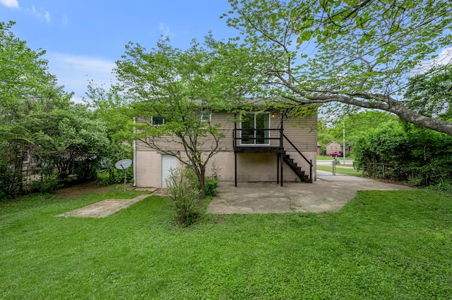 rear view of house with stairs and a patio