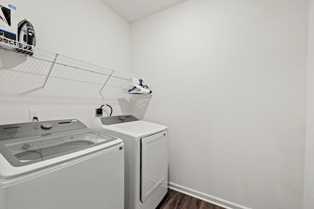 laundry area with independent washer and dryer, dark wood-style flooring, laundry area, and baseboards