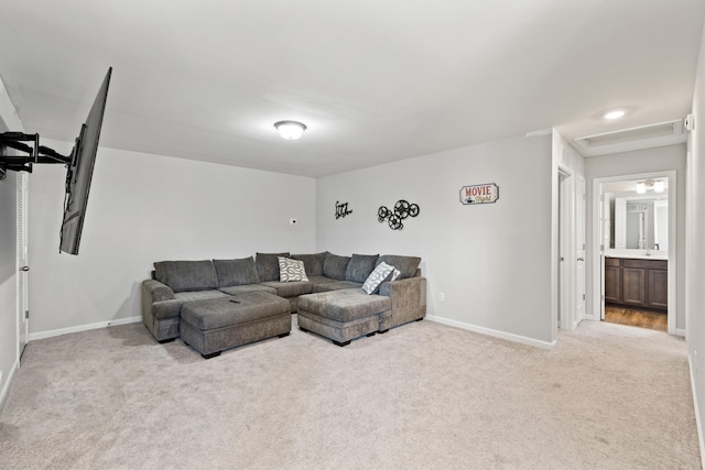 living room featuring baseboards and light colored carpet