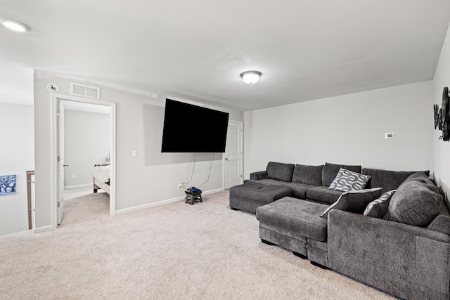 living area featuring baseboards, carpet flooring, and visible vents
