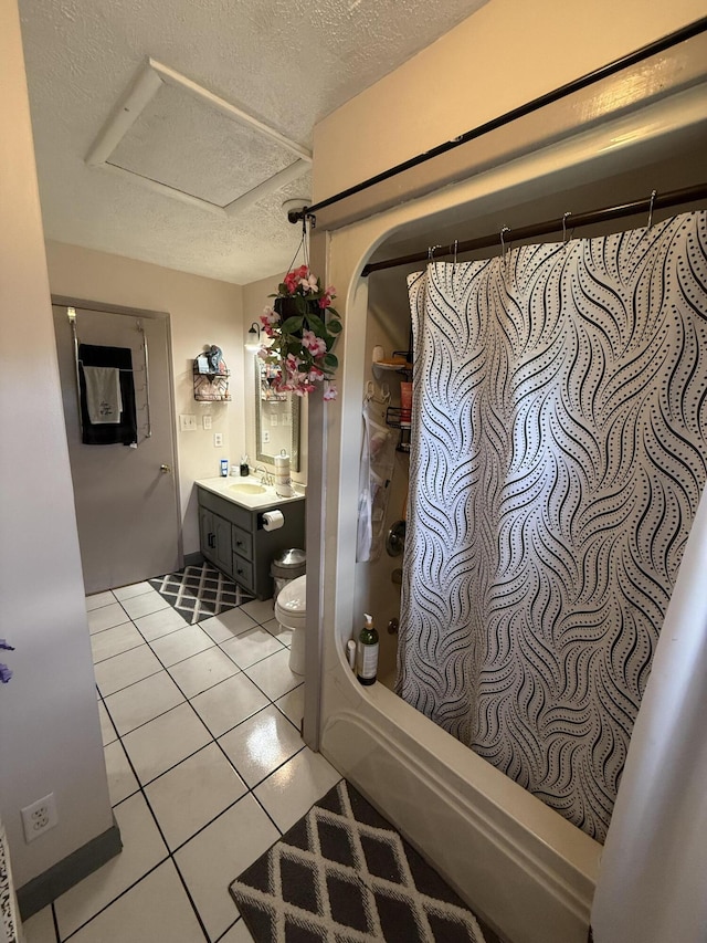 bathroom with a textured ceiling, tile patterned flooring, shower / tub combo, vanity, and toilet