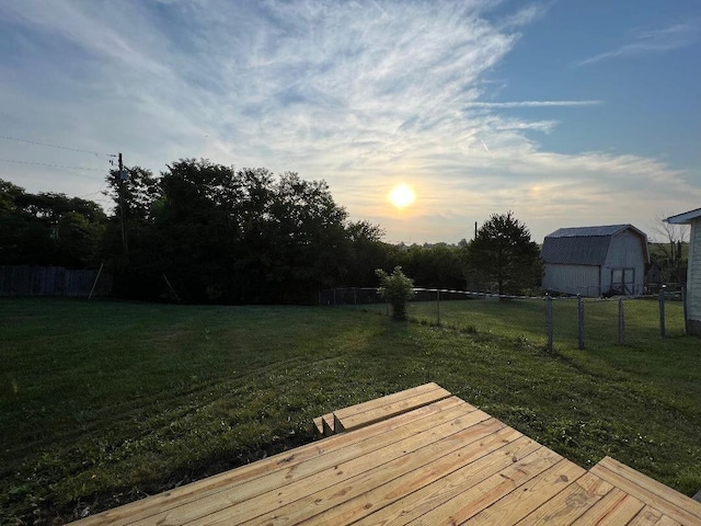 wooden terrace with fence and a lawn