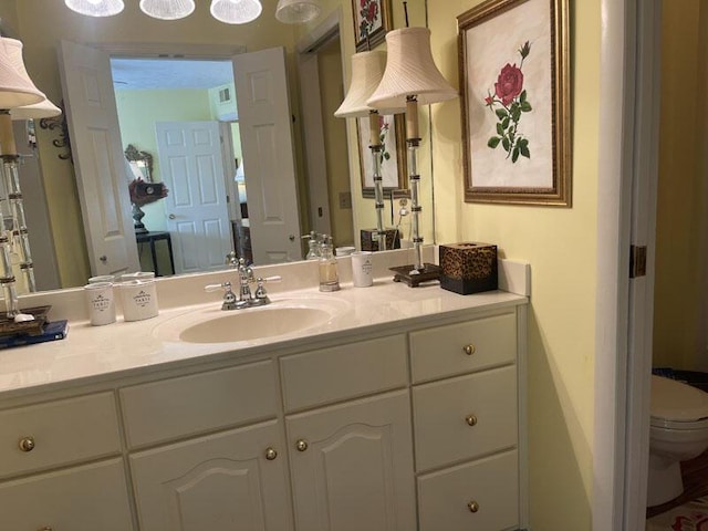 bathroom featuring toilet and vanity