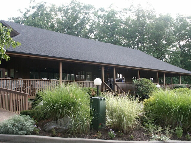 exterior space featuring a shingled roof
