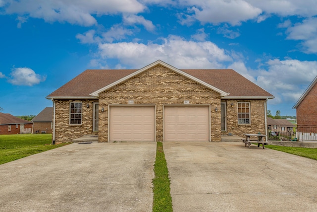ranch-style home featuring brick siding, a garage, roof with shingles, and concrete driveway