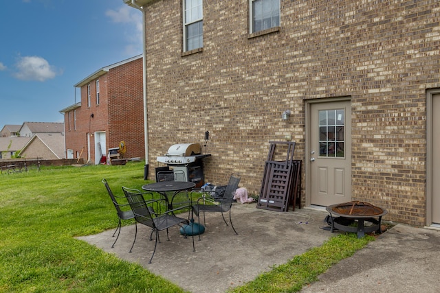view of patio with grilling area and a fire pit