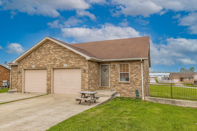 single story home with a garage, fence, a front yard, brick siding, and driveway