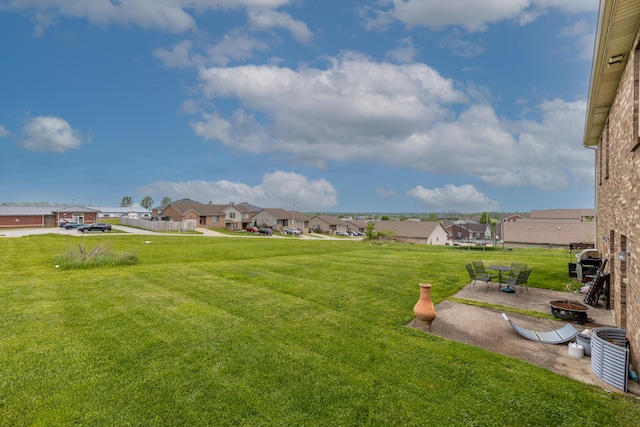 view of yard featuring a residential view and a patio