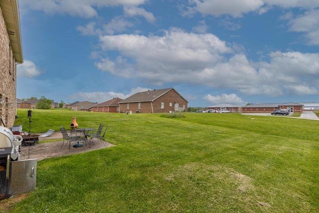 view of yard featuring a patio and a residential view