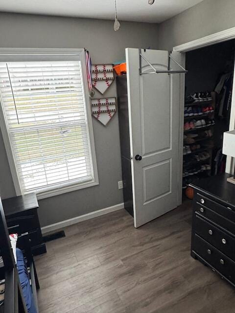 bedroom featuring baseboards and wood finished floors