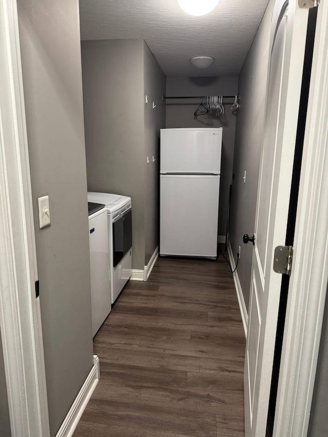 171 Elm Loop, Hustonville, KY 40437 - kitchen with freestanding refrigerator, washer and clothes dryer, dark wood-type flooring, white cabinets, and baseboards