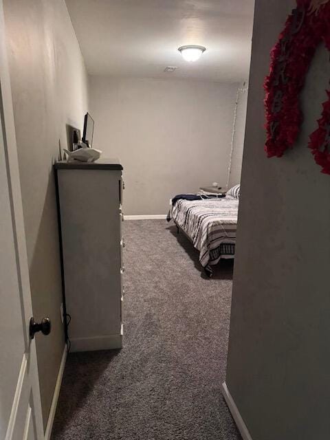 bedroom featuring baseboards and carpet flooring
