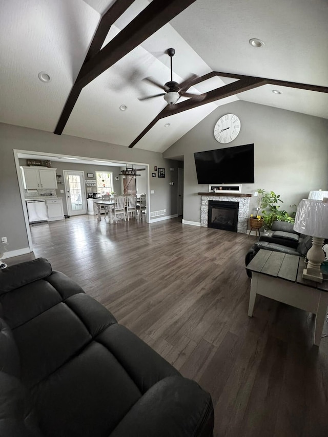 living room featuring baseboards, ceiling fan, wood finished floors, and vaulted ceiling with beams
