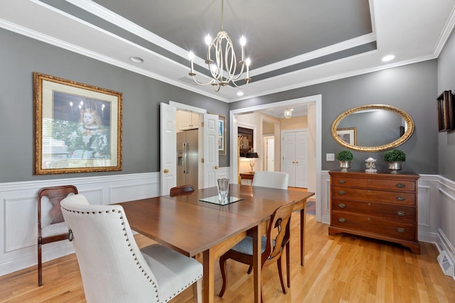 3283 Snaffle Rd, Lexington, KY 40513 - dining room with a chandelier, ornamental molding, light wood-style floors, a wainscoted wall, and a raised ceiling